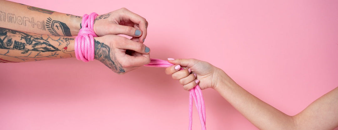 Pink rope bondage set, soft cotton material, adjustable knots for secure tying.