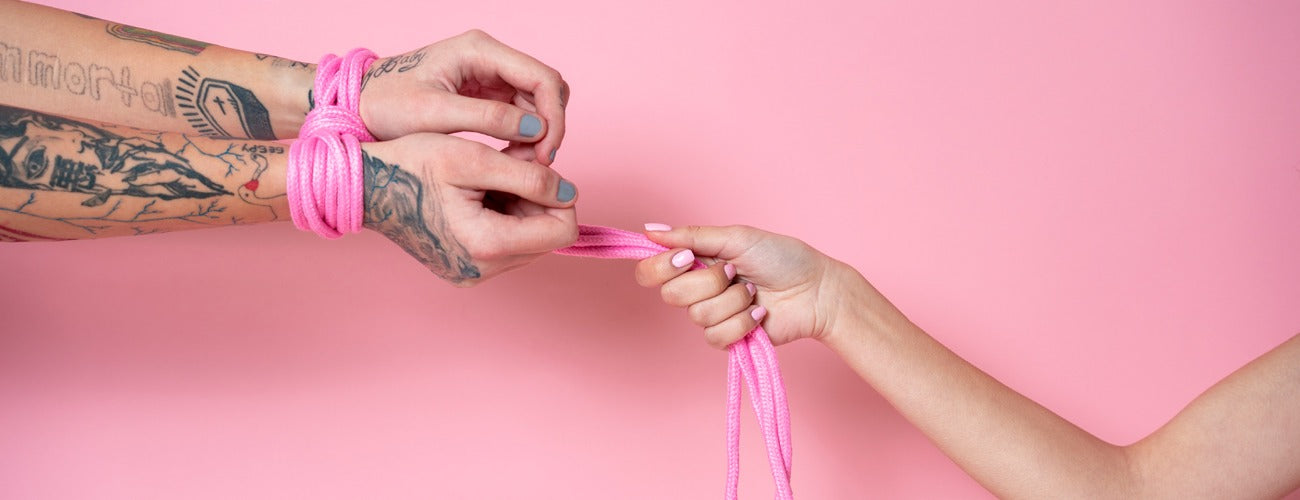 Pink rope bondage set, soft cotton material, adjustable knots for secure tying.