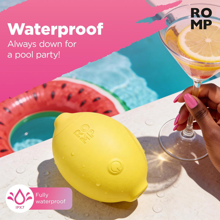 ROMP Lemon Crush yellow stimulator resting poolside, showing its waterproof design