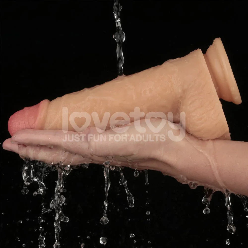 Lovetoy 9 inch Power Basics dong rinsed under running water over a hand, showing waterproof build