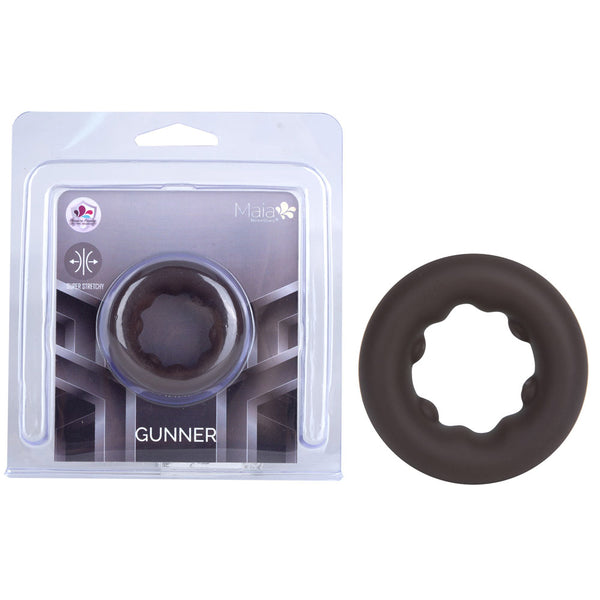 Maia Gunner cock ring in Chocolate, ridged dark brown ring beside its blister pack