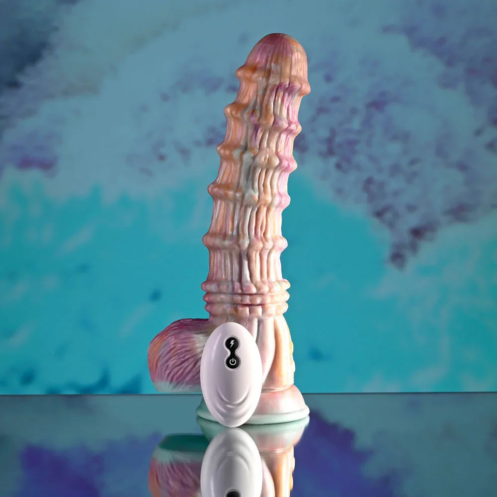 Evolved Fantasy dildo in multicolour standing on a mirrored surface, white remote in front