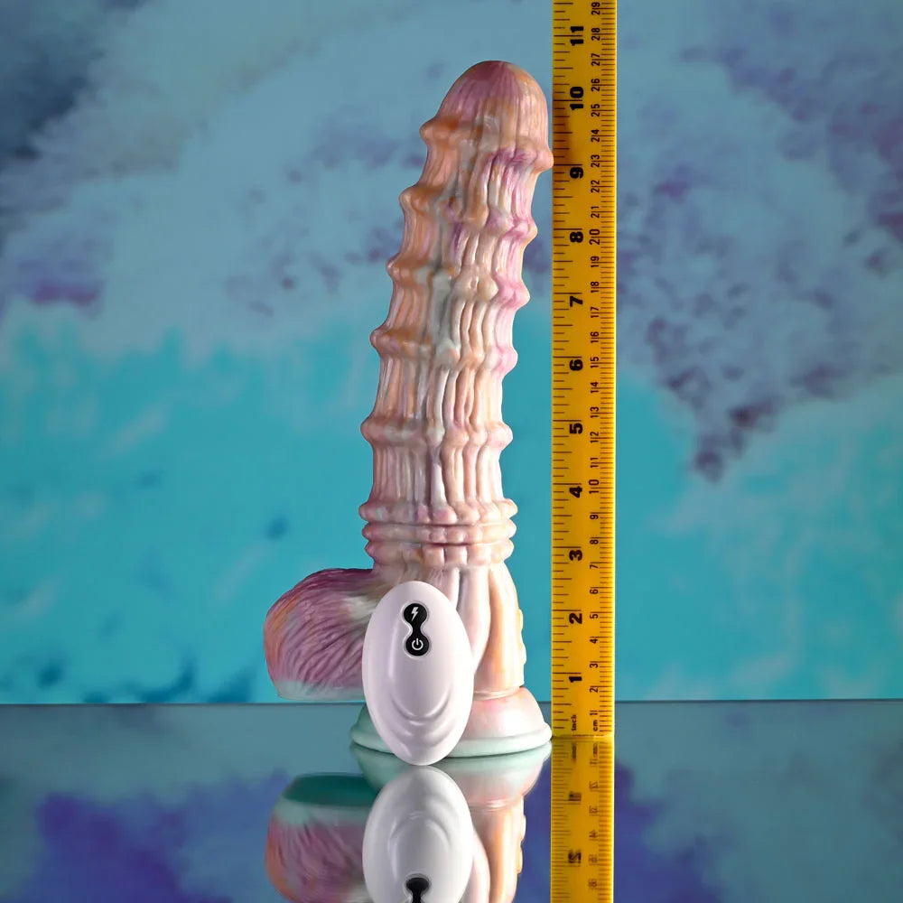 Evolved Fantasy dildo in multicolour upright beside a tape measure, reading about 10 inches