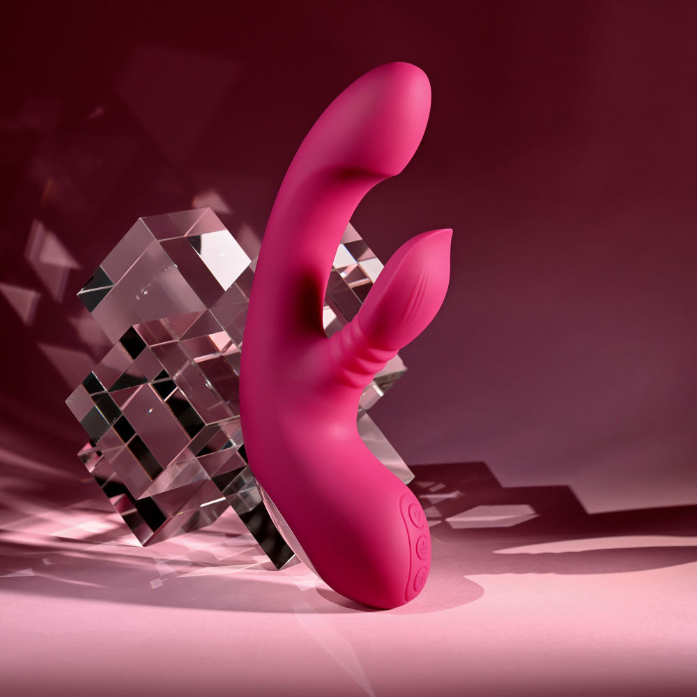 Evolved Gentle Persuasion in Pink standing against a stack of clear glass cubes, pink backdrop