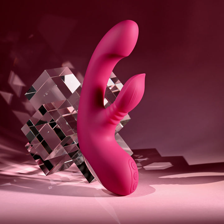 Evolved Gentle Persuasion in Pink standing against a stack of clear glass cubes, pink backdrop