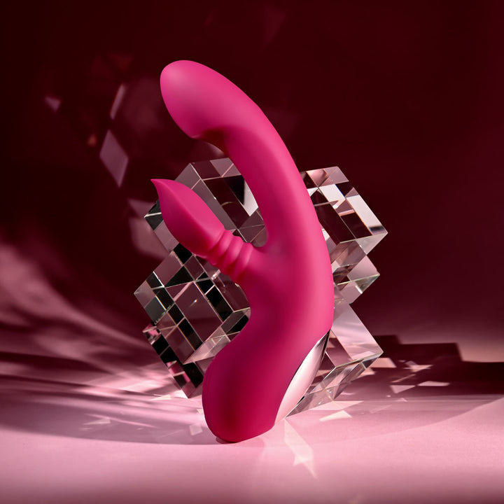 Evolved Gentle Persuasion in Pink tilted back on the glass cubes, clitoral arm pointing forward