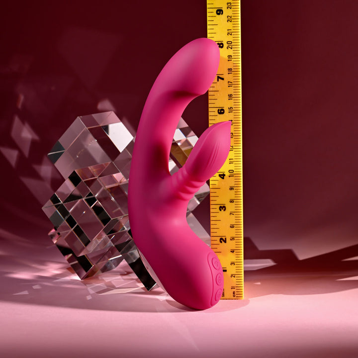 Evolved Gentle Persuasion in Pink beside an upright tape measure, reading about 8.5 inches
