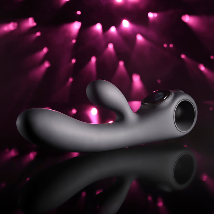 Evolved Black Magic in Black lying flat, close side profile with the clitoral arm raised