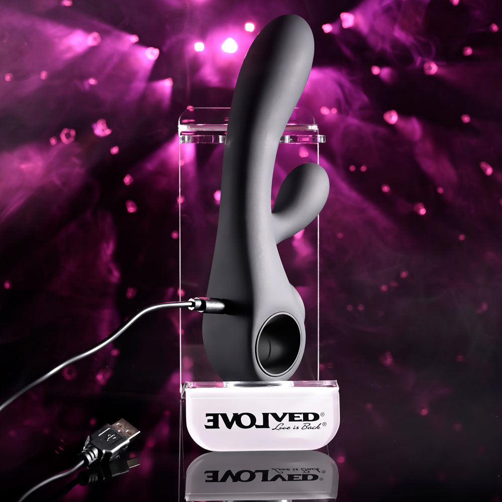 Evolved Black Magic in Black on its display stand with the charging cable clipped on