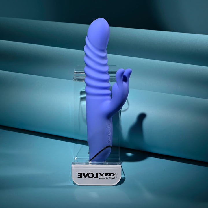 Evolved Knock Knock in blue-violet upright on a clear Evolved stand, teal ribbed backdrop