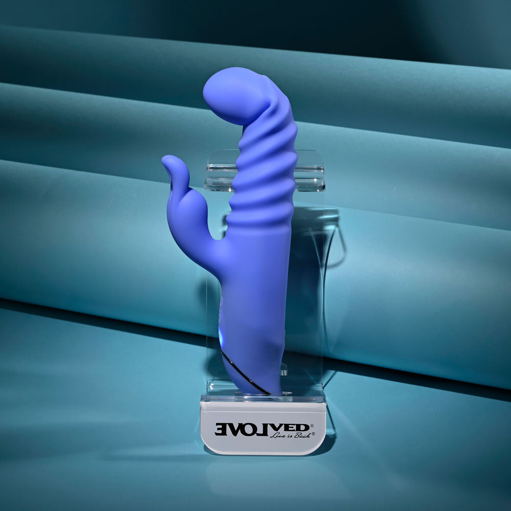Evolved Knock Knock in blue-violet on its stand, turned so the curved tip points to the right