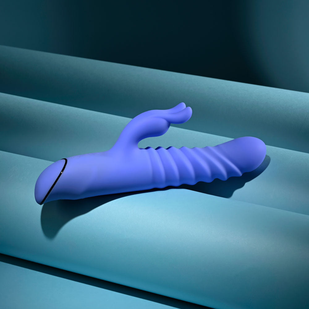 Evolved Knock Knock in blue-violet lying flat from the opposite side, ears pointing up-left