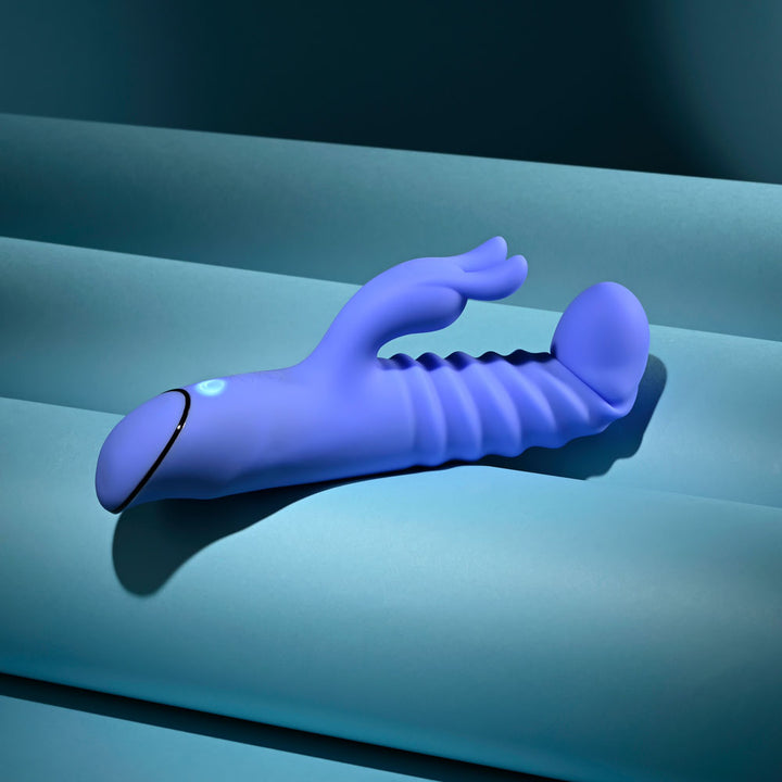 Evolved Knock Knock in blue-violet lying flat with the ribbed shaft towards the camera