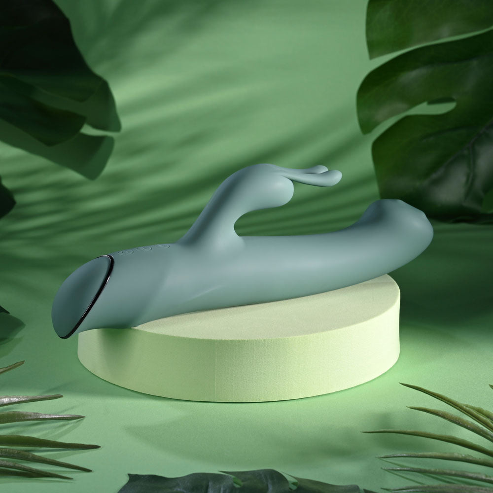 Evolved Satin Swirl in sage green on a podium, turned to show the dark cap on the handle