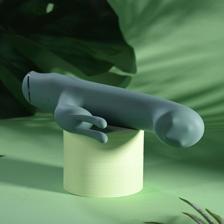 Evolved Satin Swirl in sage green balanced on a podium with the tip overhanging to the right