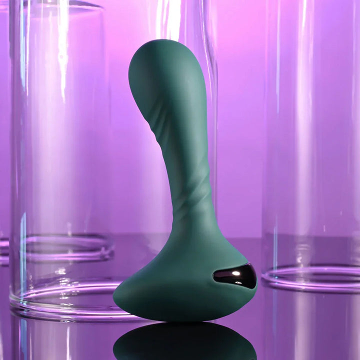 Gender X Goes Anywhere vibrator in Green upright on a mirrored surface, front view