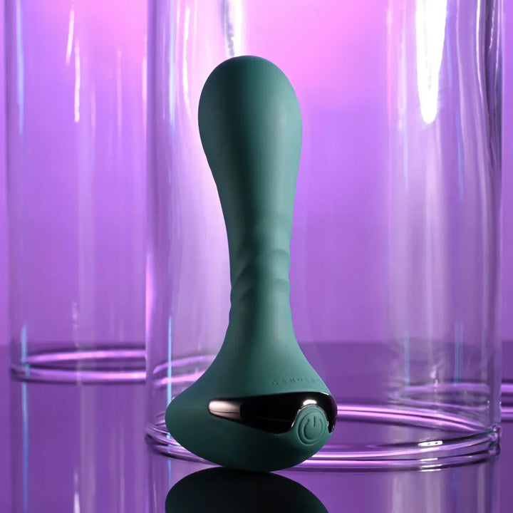 Gender X Goes Anywhere vibrator in Green upright, power button on the chrome panel