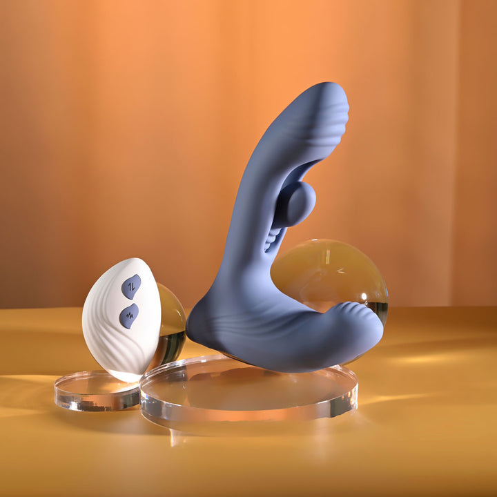 Gender X Flapjack in Blue upright on a glass disc beside its remote