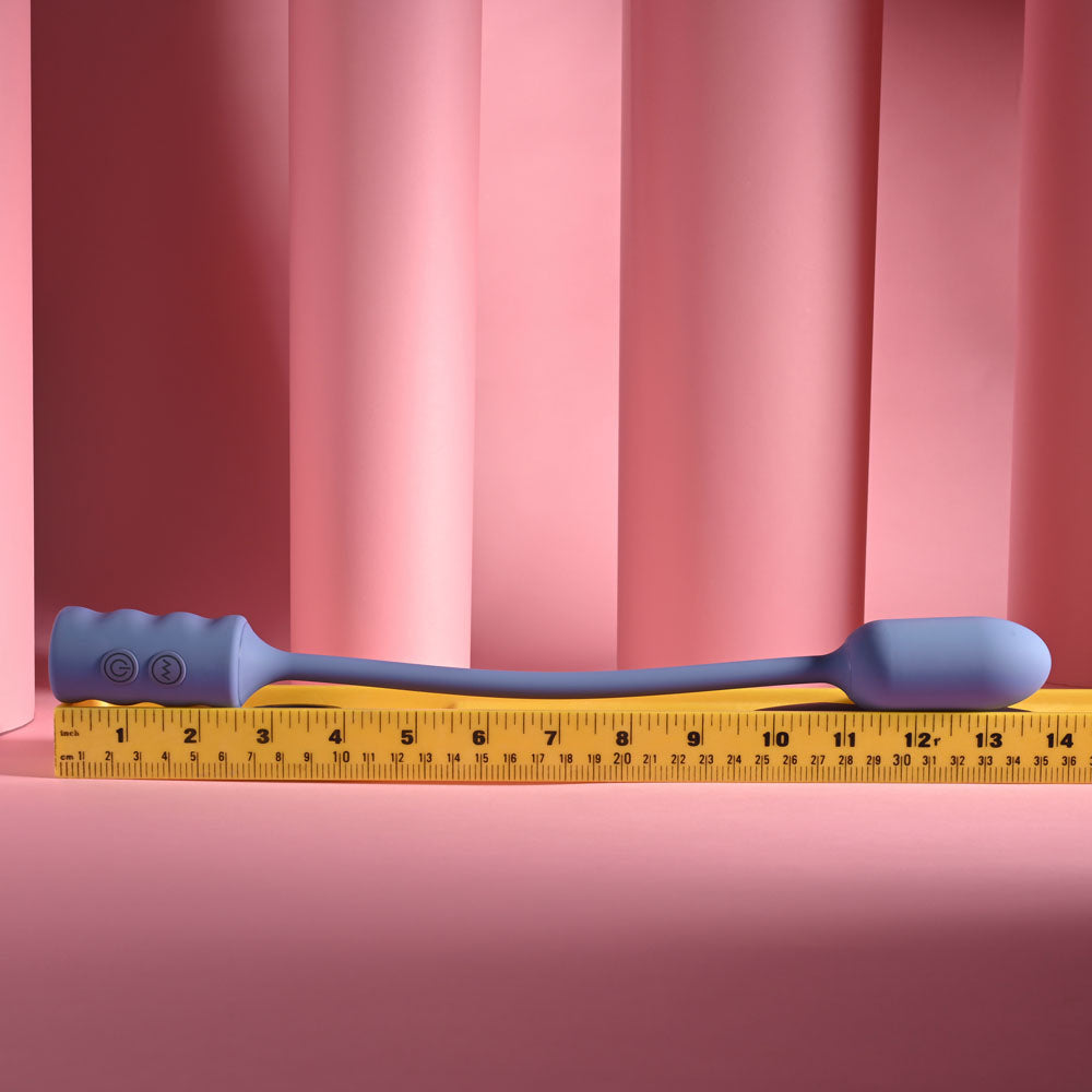 Gender X Egg-Streme in Purple laid flat along a tape measure for scale
