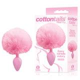 Image of The 9s Cottontails - Pink Butt Plug with Bunny Tail, featuring a fluffy pink tuft and smooth silicone plug. Next to it is the packaging with the design and slogan Every tail tells a story. Grab it at the lowest price available.