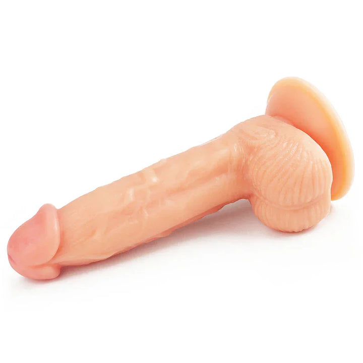 Ultra Soft Dude 8 inch dong lying on white, balls and suction cup at the back
