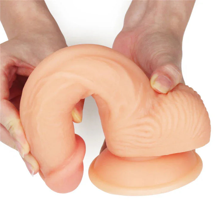 Two hands bending the Ultra Soft Dude 8 inch dong into a loop, showing extreme softness