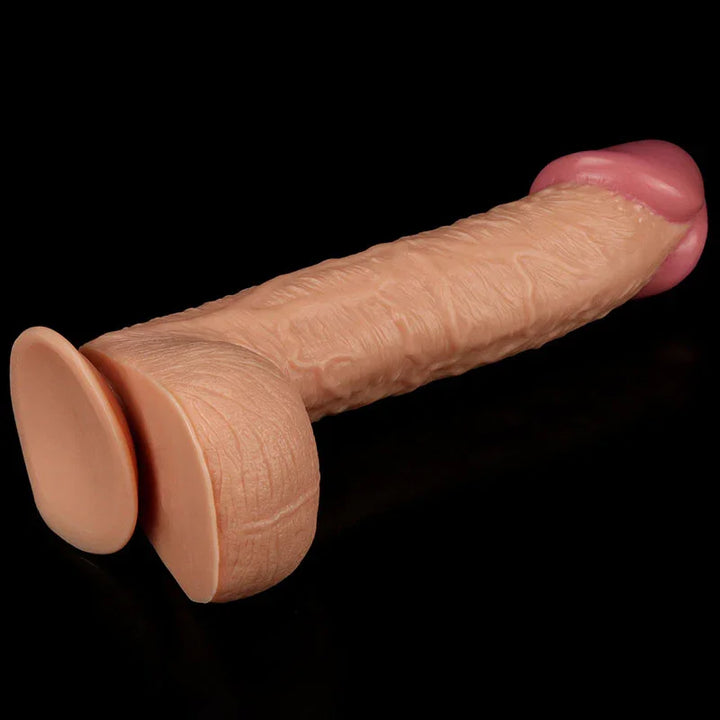 King Size 10.5 inch dildo lying on black with the suction base toward the camera