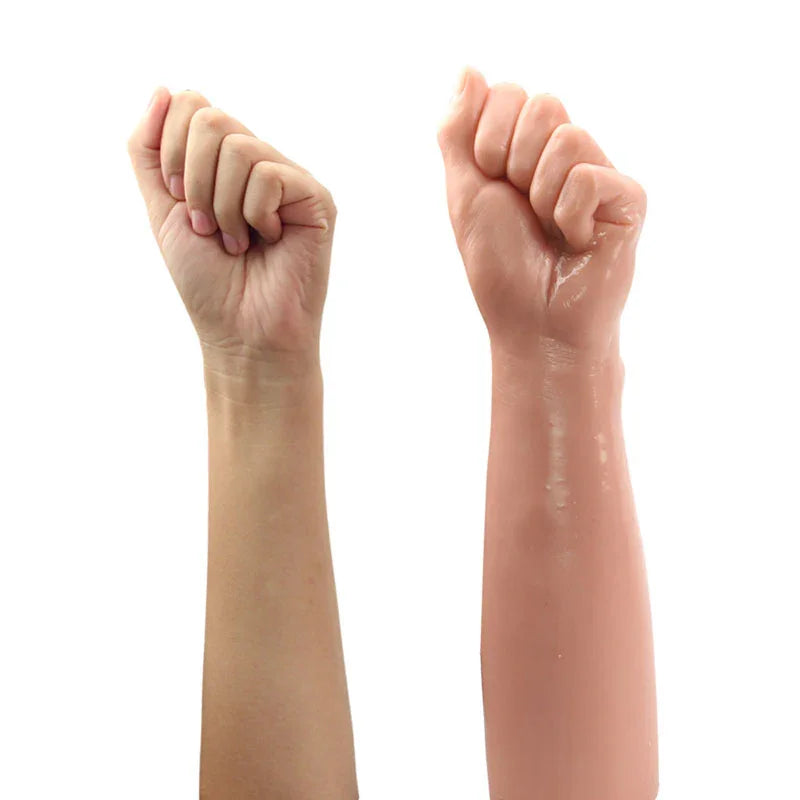 Bitch Fist dildo next to a real forearm and fist, showing the two are close to life size