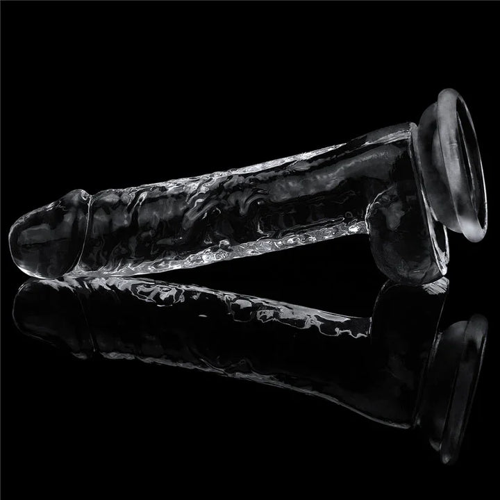 Flawless Clear 7.5 inch dildo lying on a mirrored black surface with its reflection beneath