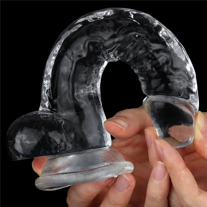 Hands bending the Flawless Clear dildo into an arch to demonstrate its flexibility