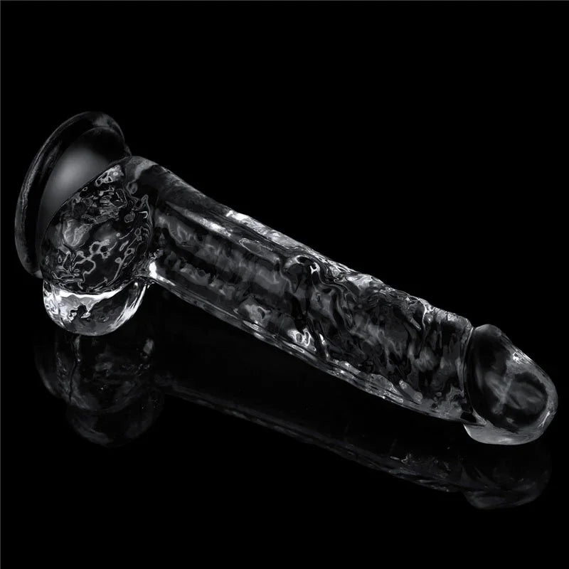 Flawless Clear 7.5 inch dildo lying flat on black, full side profile with balls and suction cup
