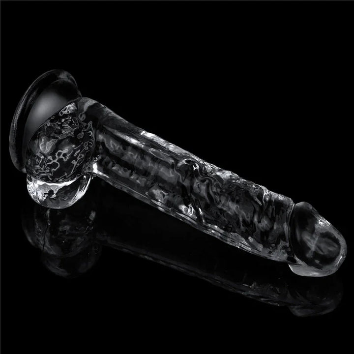 Flawless Clear 7.5 inch dildo lying flat on black, full side profile with balls and suction cup