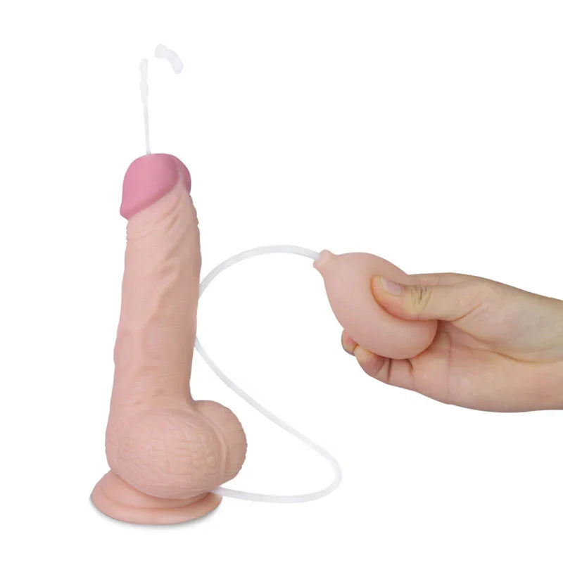 Cumming Softee dong with balls squirting from the tip while a hand presses the ejaculation bulb
