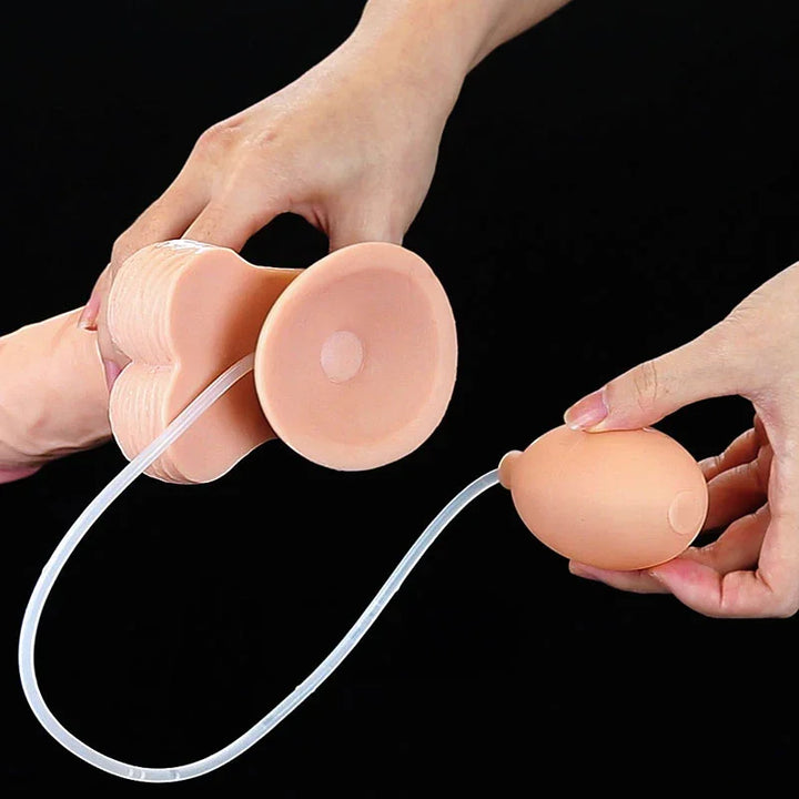 Underside of the Cumming Softee suction base with the clear tube running to the bulb in a hand