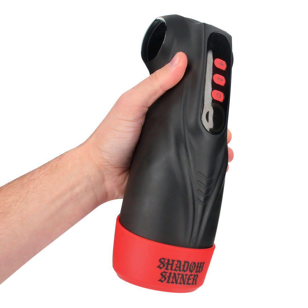 MASTURS Raven Auto Stroker, held in one hand showing the SHADOW SINNER base and side buttons