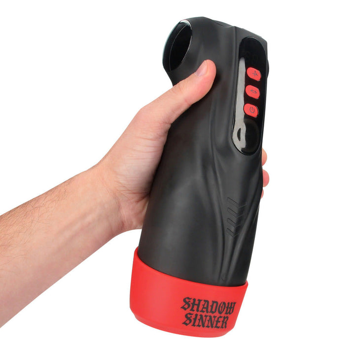 MASTURS Raven Auto Stroker, held in one hand showing the SHADOW SINNER base and side buttons
