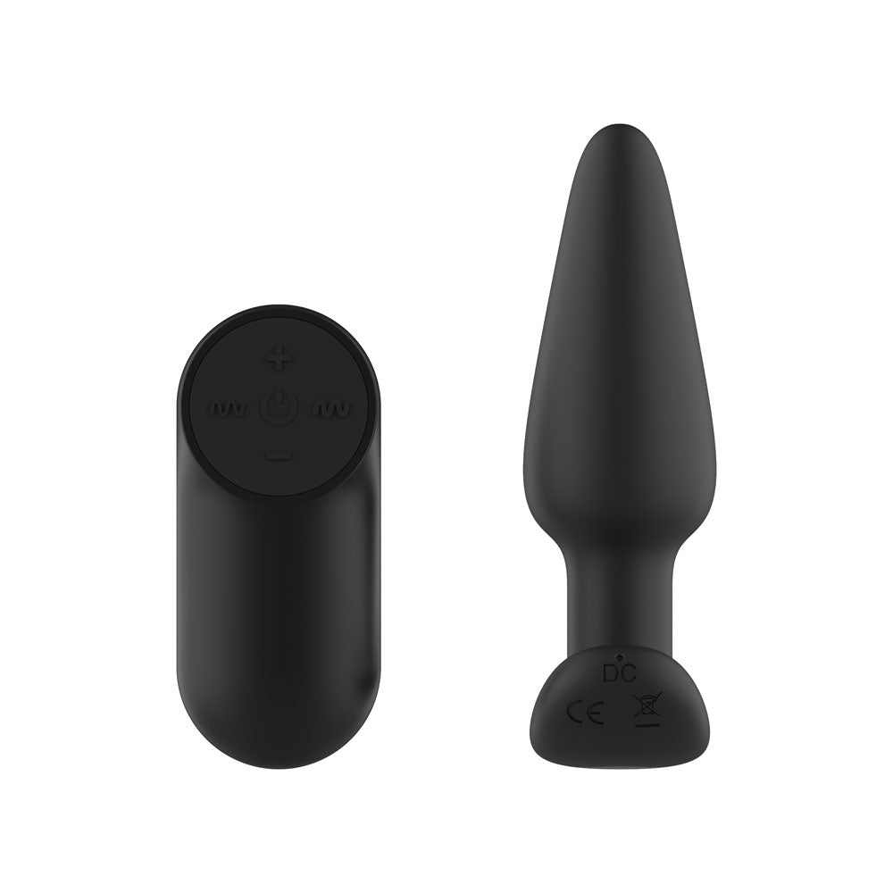 Passion Play Vibrating Butt Plug in Black upright from the back, moulded marks on the base