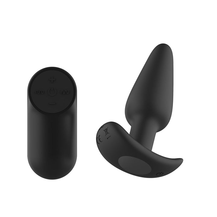 Passion Play Vibrating Butt Plug in Black angled, T-bar base to the front, remote at left