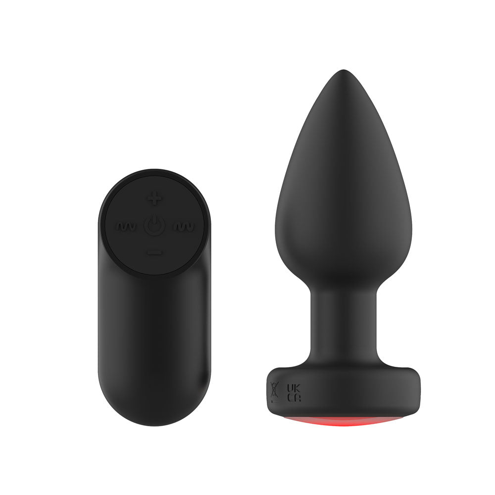 Passion Play Vibrating Butt Plug in Black upright from the back, red glow at the base rim