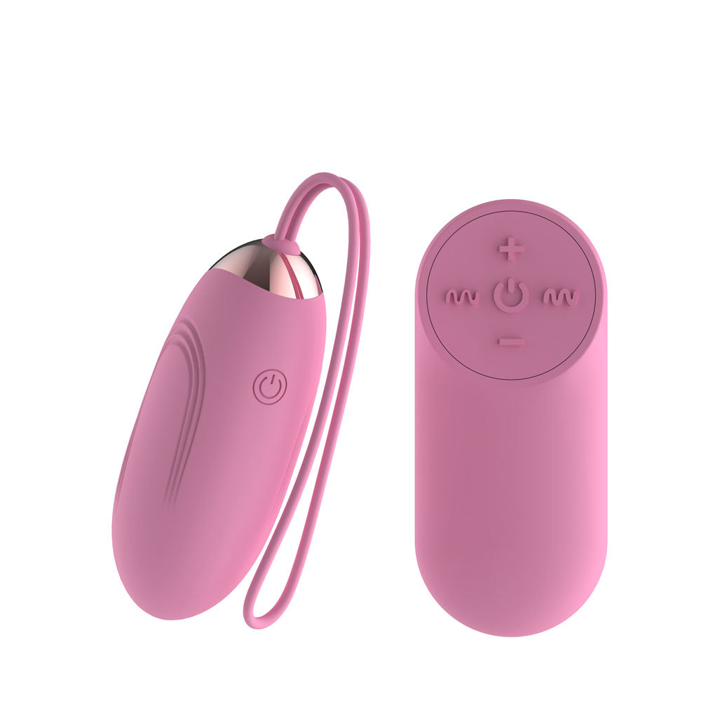 Passion Play Silicone Vibrating Egg in Pink with retrieval cord beside its oval remote