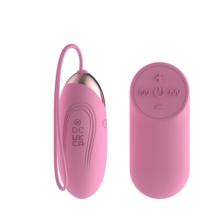 Passion Play Vibrating Egg in Pink from the back, moulded DC and UKCA marks, remote at right