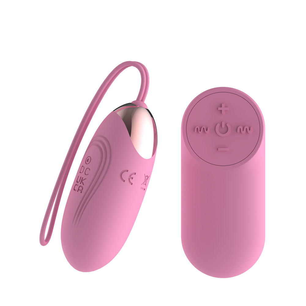 Passion Play Vibrating Egg in Pink angled with the cord looping left, remote at right
