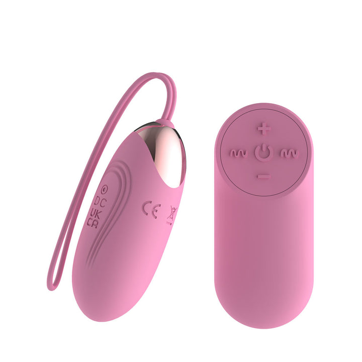 Passion Play Vibrating Egg in Pink angled with the cord looping left, remote at right