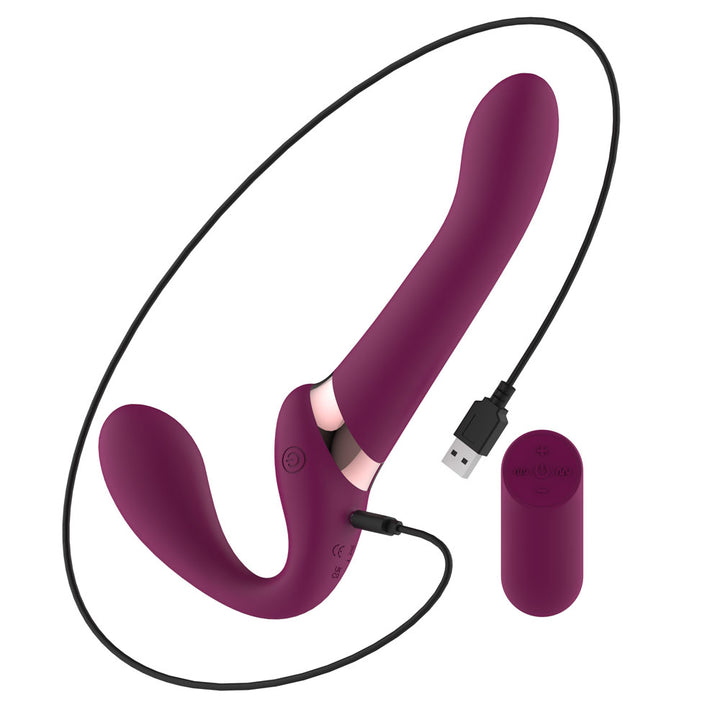 Passion Play Strap-less Dildo in Purple with its USB charging cable attached, remote at right