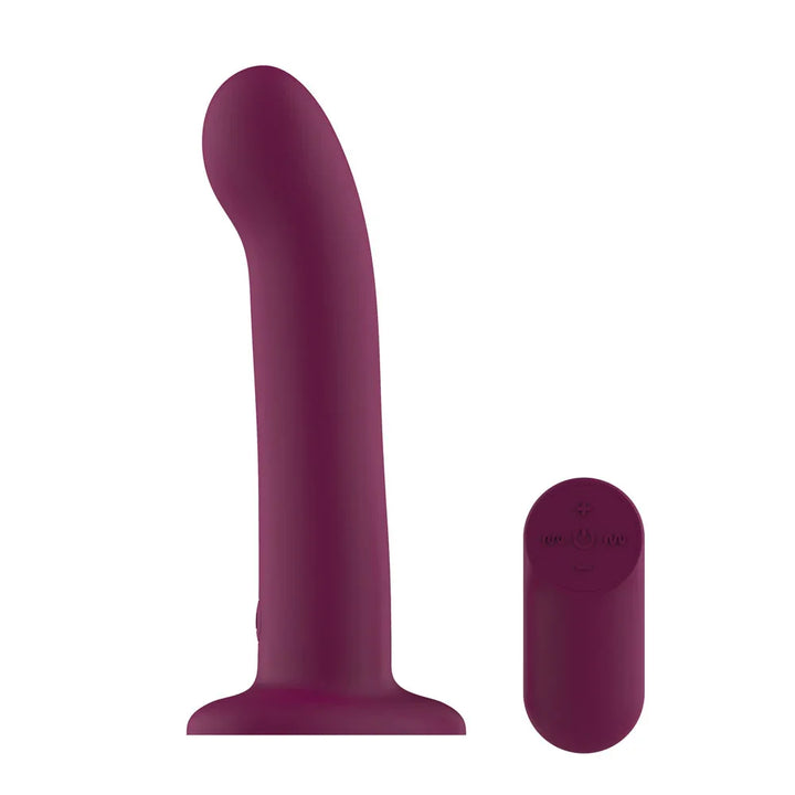 Passion Play Vibrating Dildo in Purple on its suction base beside the oval remote