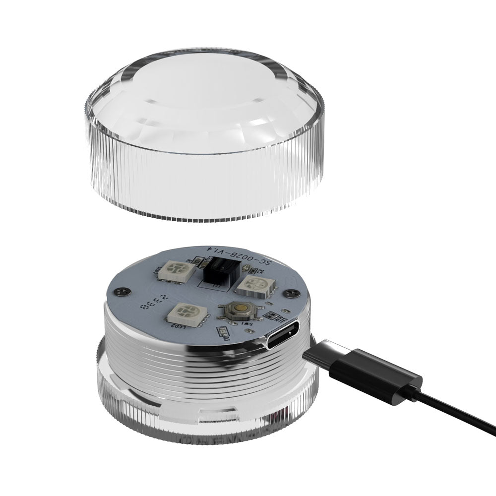 Go-Go Booty LED puck shown assembled and open with its USB charging cable
