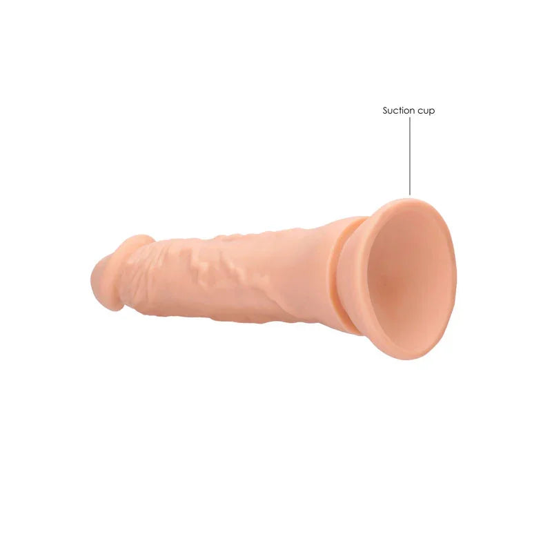 REALROCK 22.9 cm Realistic Dildo in Flesh, lying flat with the suction cup labelled