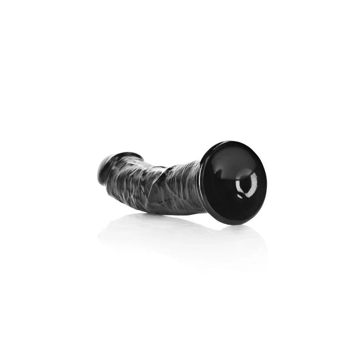 REALROCK 18 cm Realistic Curved Dildo in Black, lying down with the suction base facing the camera