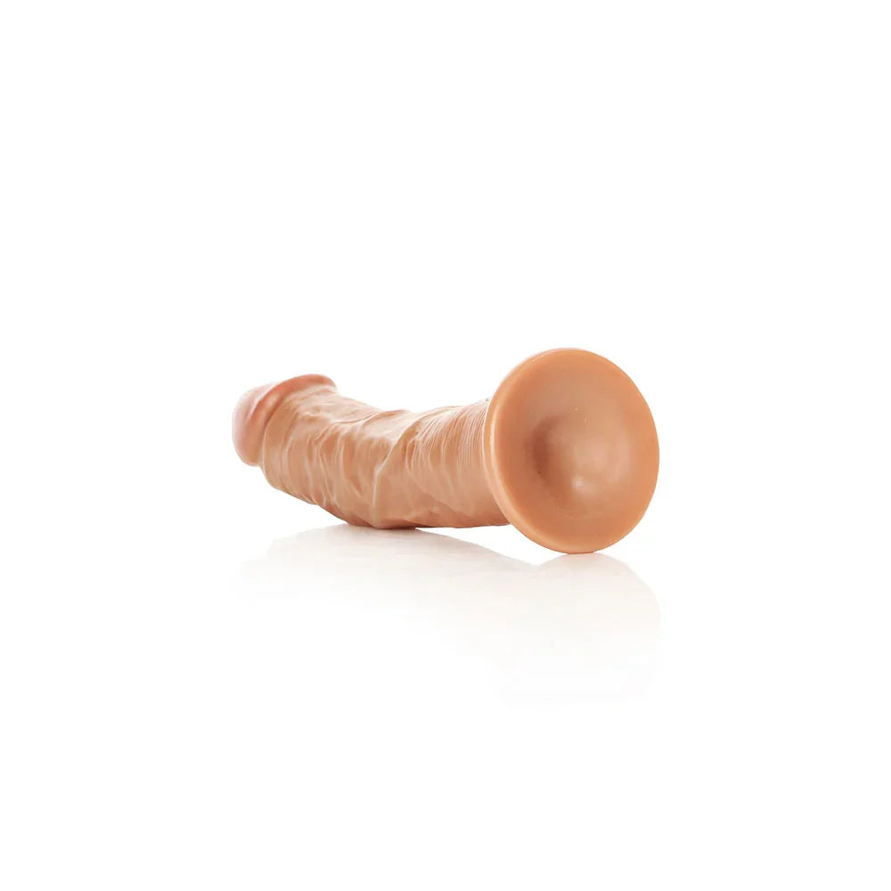 REALROCK 18 cm Realistic Curved Dildo in Tan, lying down with the suction base facing the camera