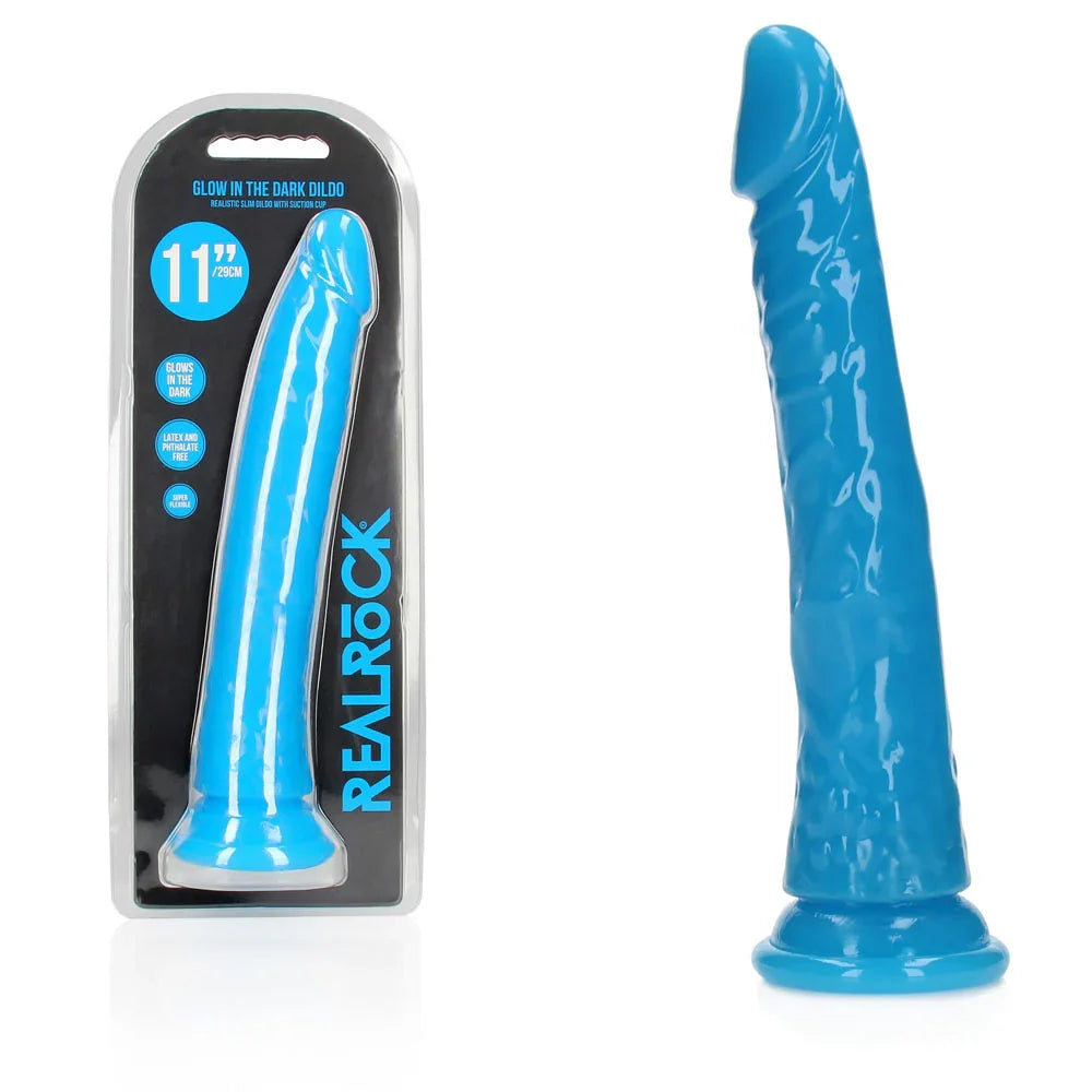 REALROCK 28 cm Glow in the Dark Slim Dildo in Blue, blister pack beside the neon blue dildo